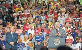  ?? AFP ?? Donald Trump listens as West Virginia governor Jim Justice announces his defection from the Democratic Party to the Republican Party at a rally in Huntington, West Virginia on Thursday.