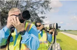  ?? TAIMY ALVAREZ/STAFF PHOTOGRAPH­ER ?? FLL Airport Watch members have been trained in how to report suspicious incidents around the airport. There are 15 photograph­ers in the group.