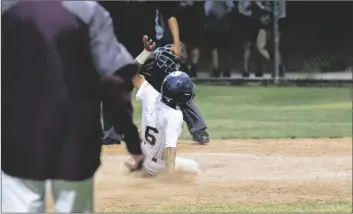  ?? CAMILO GARCIA JR. PHOTO ?? LEFT: Calexico junior Randy Baez slides into home scoring the winning run in the tenth inning giving the Bulldogs a 2-1 victory over the Southwest Eagles at Belcher Field on Wednesday night in Calexico.