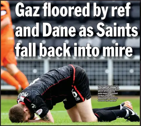  ??  ?? Saints defender Gary Mackenzie lies on the pitch after being pole-axed by United striker Thomas Mikkelsen who then scored the opener