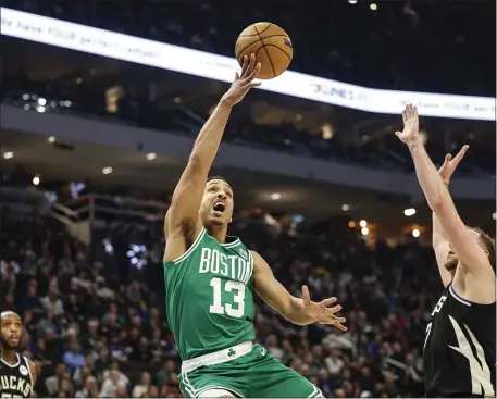  ?? JEFFREY PHELPS — THE ASSOCIATED PRESS ?? Boston Celtics guard Malcolm Brogdon (13) drives against Milwaukee Bucks player Joe Ingles during Tuesday night’s game in Milwaukee.