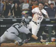  ?? The Associated Press ?? COMING HOME: Jose Altuve scores the winning run past Yankee catcher Gary Sanchez as the Houston Astros beat New York 2-1 for the second-straight game in the American League Championsh­ip Series. Game 3 in the best-of-seven series is Monday at Yankee...