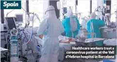  ??  ?? Healthcare workers treat a coronaviru­s patient at the Vall d’hebron hospital in Barcelona