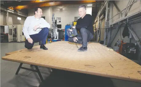  ?? PHOTOS: NICK BRANCACCIO ?? Boris Novakovic, left, and Chris Holtkamp stand on a Dura-base floor, their company’s largest project to date.