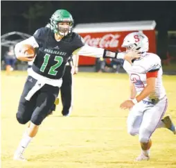  ?? STAFF PHOTO BY MATT HAMILTON ?? East Hamilton’s Haynes Eller runs past Sullivan South’s Jackson McGee during their Class 4A playoff game last Friday. Eller passed for more than 300 yards in the Hurricanes’ 56-20 victory.