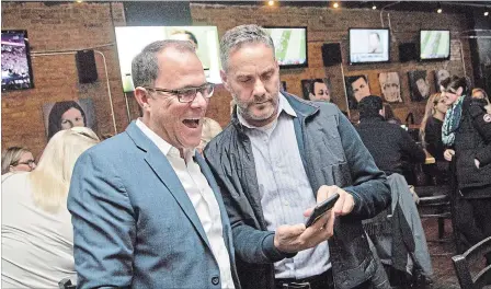  ?? BOB TYMCZYSZYN THE ST. CATHARINES STANDARD ?? Walter Sendzik, left, after being re-elected mayor ofSt. Catharines, is joined by Jason Pollock at Kully’s Original Sports Bar to watch the polls come in.