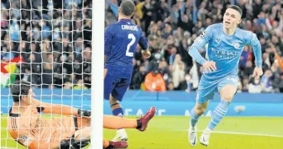  ?? AP ?? Manchester City’s Phil Foden celebrates after scoring his side’s third goal during the Champions League semi-final, first leg match between Manchester City and Real Madrid at the Etihad stadium in Manchester, England yesterday. Manchester City won 4-3.