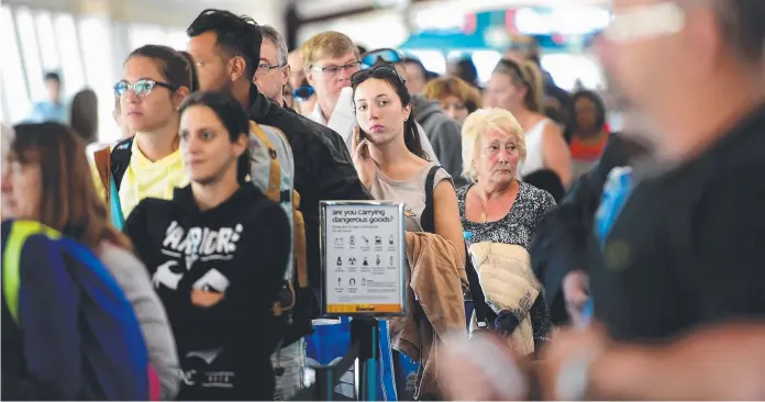  ?? Pictures: SCOTT RADFORD- CHISHOLM ?? OFF TO MELBOURNE: Passengers line up to board a flight at Townsville Airport yesterday which logged record numbers last month.