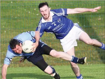  ??  ?? Conor Dillon, Kilbride takes a tumble under a challenge from Francis Simpson, Shillelagh.