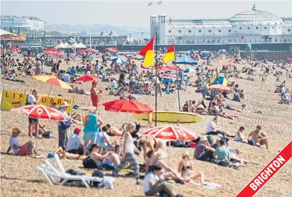  ??  ?? ...but it was a totally different scene on the south coast as thousands flocked to the beach to catch the rays