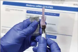  ?? HANS PENNINK — THE ASSOCIATED PRESS FILE ?? A nurse prepares a shot as a study of a possible COVID-19 vaccine, developed by the National Institutes of Health and Moderna Inc., gets underway in Binghamton, N.Y.