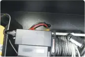  ??  ?? 23
With the excess wire we had from the battery relocation kit, we ran a positive and negative wire through the floor of the toolbox and out the bottom of the trailer. We then grounded the black (negative) wire to the chassis of the trailer, ran another black wire off the ground point forward with the red (positive) wire, loomed them in a mesh wire loom and routed them toward the front of the trailer.