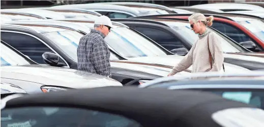  ??  ?? In this April 5 photo, a couple considers a sedan in a long row of 2020 models on display at a Mercedes Benz dealership in Littleton, Colo. Long-term auto loans allow people to spend more on a car while keeping the payments low. But issues down the road can prove costly.