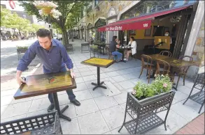  ?? Matthew Brown / Hearst Connecticu­t Media ?? Owner Alain Bars of Chez Vous Bistro on Bedford Street in Stamford sets up his extended outdoor dining area on May 30.