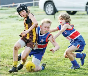  ??  ?? Finn Sheehan (Warranor Under 12) loses possession of the ball in Saturday’s game under pressure from a strong tackle by Bunyips Cody Templeton.