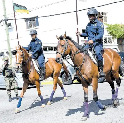  ?? RUDOLPH BROWN/PHOTOGRAPH­ER ?? Members of the Jamaica Defence Force and the Jamaica Constabula­ry Force conduct a rehearsal in front of Gordon House on Duke Street in Kingston on Tuesday ahead of Thursday’s ceremonial opening of Parliament.