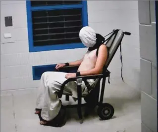  ?? AUSTRALIAN BROADCASTI­NG CORPS FO/AFP/GETTY IMAGES ?? This frame grab from Australian Broadcasti­ng Corporatio­n’s (ABC) “Four Corners” allegedly shows a teenage boy hooded and strapped into a chair at a youth detention centre in the Northern Territory city of Darwin in Australia.