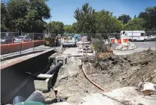  ?? Gabrielle Lurie / The Chronicle ?? Repair work has begun at the intersecti­on of Rheem Boulevard and Center Street, where a big sinkhole opened in March 2016.