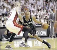  ?? WILFREDO LEE ASSOCIATED PRESS ?? San Antonio guard Patty Mills drives around Miami forward Chris Andersen in the second half on Tuesday night. The Spurs rode their magnificen­t shooting in the first half to a 111-92 win and 2-1 lead in the NBA Finals.