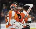  ?? DERIK HAMILTON — THE ASSOCIATED PRESS ?? Philadelph­ia Flyers goalie Brian Elliott celebrates with Jakub Voracek after a 6-3 victory over the St. Louis Blues Saturday in Philadelph­ia.