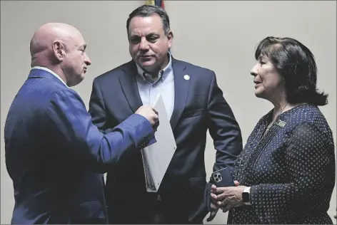  ?? ?? U.S. SEN. MARK KELLY (D-ARIZ.) (LEFT) TALKS WITH YUMA MAYOR Doug Nicholls (center) and former Arizona state senator and representa­tive Amanda Aguirre following Kelly’s news conference Friday afternoon inside the conference room at the Yuma County Department of Developmen­t Services, 2351 W. 26th St.