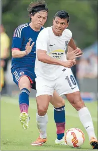  ??  ?? Keep away: Takuya Iwata of Auckland protects the ball from Shinji Okazaki of Japan.