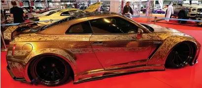  ?? —Photo by Ryan Lim ?? The Gold Godzilla at the Internatio­nal Motor Show at the Abu Dhabi National Exhibition Centre. This is the first time the car is travelling out of Japan, and Nissan hopes to seII it here.