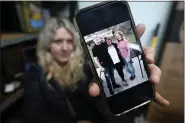  ?? CARLOS OSORIO — THE ASSOCIATED PRESS ?? Lisa Hohnstreit­er holds a smartphone displaying a photograph of her mother, Nancy Harrison, and her brother, Friday, Nov. 24, 2023, in Warren, Mich. Not long after Deangelo Martin was released from jail, he killed for the second time. On March 19, 2019, the body of Nancy Harrison, 52, was discovered in an abandoned house on Coventry Street.