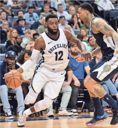  ?? AP FILE PHOTO ?? Memphis Grizzlies guard Tyreke Evans (12) drives against Denver Nuggets forward Wilson Chandler, right, in the first half of an NBA basketball game Saturday, March 17, 2018, in Memphis, Tenn.