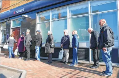  ??  ?? Queueing customers outside the NatWest Bank in Snodland which has now closed