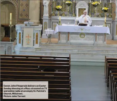 ??  ?? Canon John Fitzgerald delivers an Easter Sunday blessing at a Mass streamed on TV and online radio at an empty St. Patrick’s Church, Millstreet.
Picture John Tarrant
