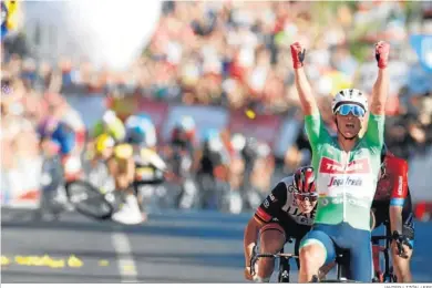  ?? JAVIER LIZÓN / EFE ?? El danés Mads Pedersen celebra su triunfo en la meta de Tomares mientras Roglic se levanta al fondo tras su caída.