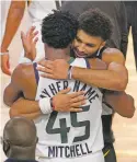  ??  ?? The Jazz’s Donovan Mitchell (45) and the Nuggets’ Jamal Murray greet each other after Denver ended Utah’s season.