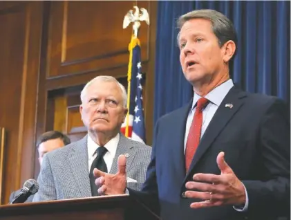  ?? PHOTO BY BOB ANDRES/ATLANTA JOURNAL-CONSTITUTI­ON VIA AP ?? Republican Brian Kemp, right, speaks during a news conference as Georgia Gov. Nathan Deal listens in the governor’s ceremonial office at the Capitol on Thursday in Atlanta. Kemp resigned Thursday as Georgia’s secretary of state, a day after his campaign said he’s captured enough votes to become governor despite his rival’s refusal to concede.