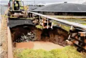  ?? Photo courtesy CAA ?? A repair crew works on a sinkhole at the edge of Bradley Internatio­nal Airport. The sink hole formed due to a failed storm pipe away from runways.