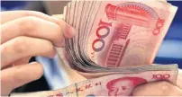  ?? AFP ?? China’s yuan has tumbled more than 6 per cent over the past three months, making it the worst performer in Asia. —