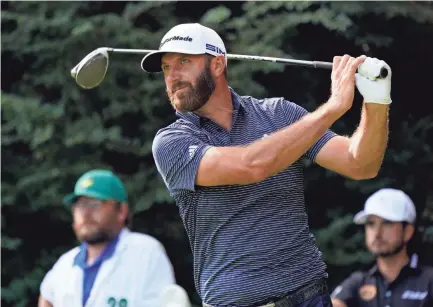  ?? ROB SCHUMACHER/USA TODAY SPORTS ?? Dustin Johnson tees off on the 14th hole during the final round of the Masters. Johnson completed the climb to No. 1 in the world the first time in 2017 and has stayed there for the better part of the three years.