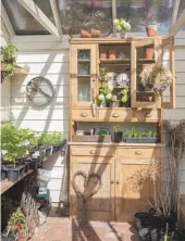  ??  ?? An old dresser in the greenhouse adds to the rustic charm of this practical space