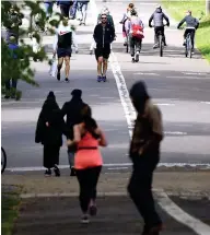  ??  ?? Running sore: People at the Meadows, in Edinburgh. Left: Cars at the Devil’s Pulpit