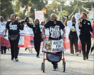  ?? Stephen B. Morton / Associated Press ?? Annie Polite, 87, of Brunswick, Ga., walks with her walker in front of a protest march as part of a Wall of Prayer event outside the Glynn County Courthouse in Brunswick, Ga. The Rev. Al Sharpton organized the event after defense attorney Kevin Gough to objected to the presence of Black pastors in the courtroom.