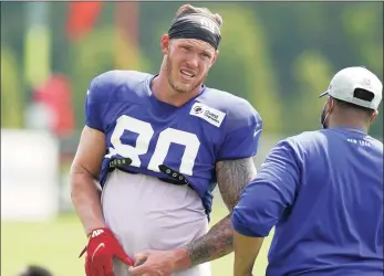  ?? Steven Senne / Associated Press ?? Giants tight end Kyle Rudolph (80) removes his gloves before facing reporters following a joint practice with the New England Patriots in Foxborough, Mass., on Aug. 25. Rudolph signed as a free agent in the offseason. He did not play in any of the three preseason games because of offseason surgery on his foot.