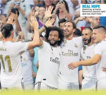  ??  ?? REAL HOPE Madrid joy at Karim Benzema’s (second right) goal was short-lived