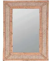  ?? USA TODAY NETWORK PHOTOS ?? The 24-by-36-inch Ash rattan wall mirror creates a coastal mood. $399 at potterybar­n.com.