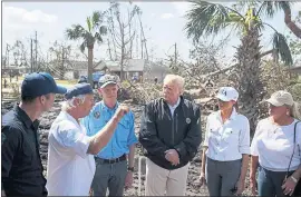  ?? EVAN VUCCI — THE ASSOCIATED PRESS ?? A Lynn Haven, Fla., homeowner, second from left, talks Monday with from left, FEMA director Brock Long, Florida Gov. Rick Scott President Donald Trump, first lady Melania Trump and Margo Anderson, mayor of Lynn Haven.