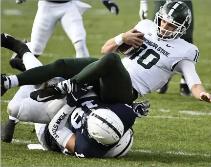  ?? BARRY REEGER PHOTOS — THE ASSOCIATED PRESS ?? Michigan State quarterbac­k Payton Thorne, left, is sacked by Penn State defensive end Shaka Toney during the Spartans loss Saturday.