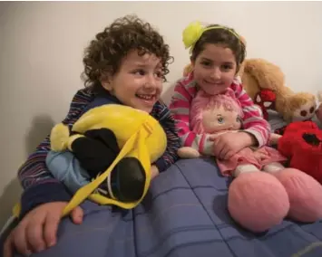  ?? RICK MADONIK/TORONTO STAR ?? Feras, left, 4, and Hoda, 6, hang out in their room with a collection of stuffed toys. The children immigrated to Canada on Dec. 21 with their parents, Hamzeh Morad, 32, and his wife, Ghader Bsmar, 25, after fleeing the civil war in Syria.