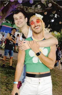  ?? Photograph­s by Chiara Alexa For The Times ?? “IT’S SO important that Pride is happening [here] because it gives an example to other countries,” says Vlad Rabcheniuk, with Addy Benavides at WeHo Pride.