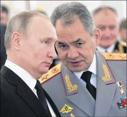  ?? AP photo ?? Russian President Vladimir Putin, left, and Defence Minister Sergei Shoigu talk during an awards ceremony for troops who fought in Syria, at the Kremlin in Moscow, Russia. Putin says Russia’s action in Syria has demonstrat­ed the power of the nation’s...