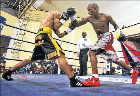  ?? Picture: MARK ANDREWS ?? FIGHTING SPIRIT: Lwandile Sityatha, right, launches a right-hand punch against Michael Dasmarinas during the IBO world junior bantamweig­ht title bout at the Orient Theatre, in East London on Saturday. Sityatha secured a points victory to retain his crown