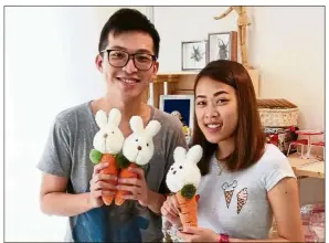  ??  ?? Lean (left) and his student Kaylee Tan with their ‘carrot bunny’ sock toys. — Lean CHIN KEONG